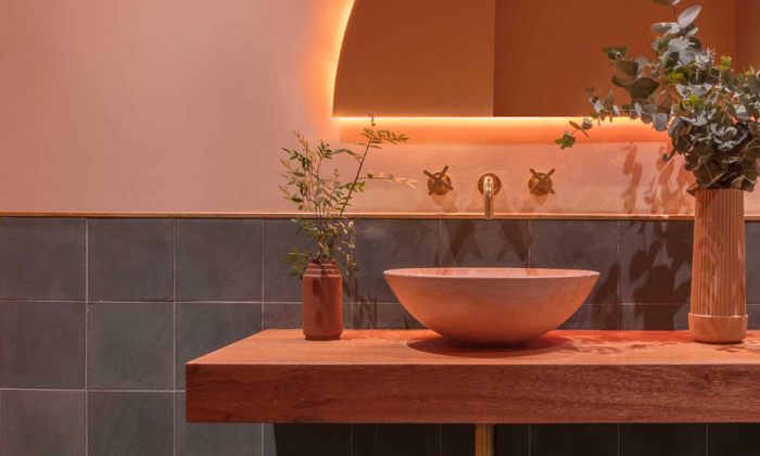 Bathroom sink and mirror in terracotta colors; image curtesy of WGSN