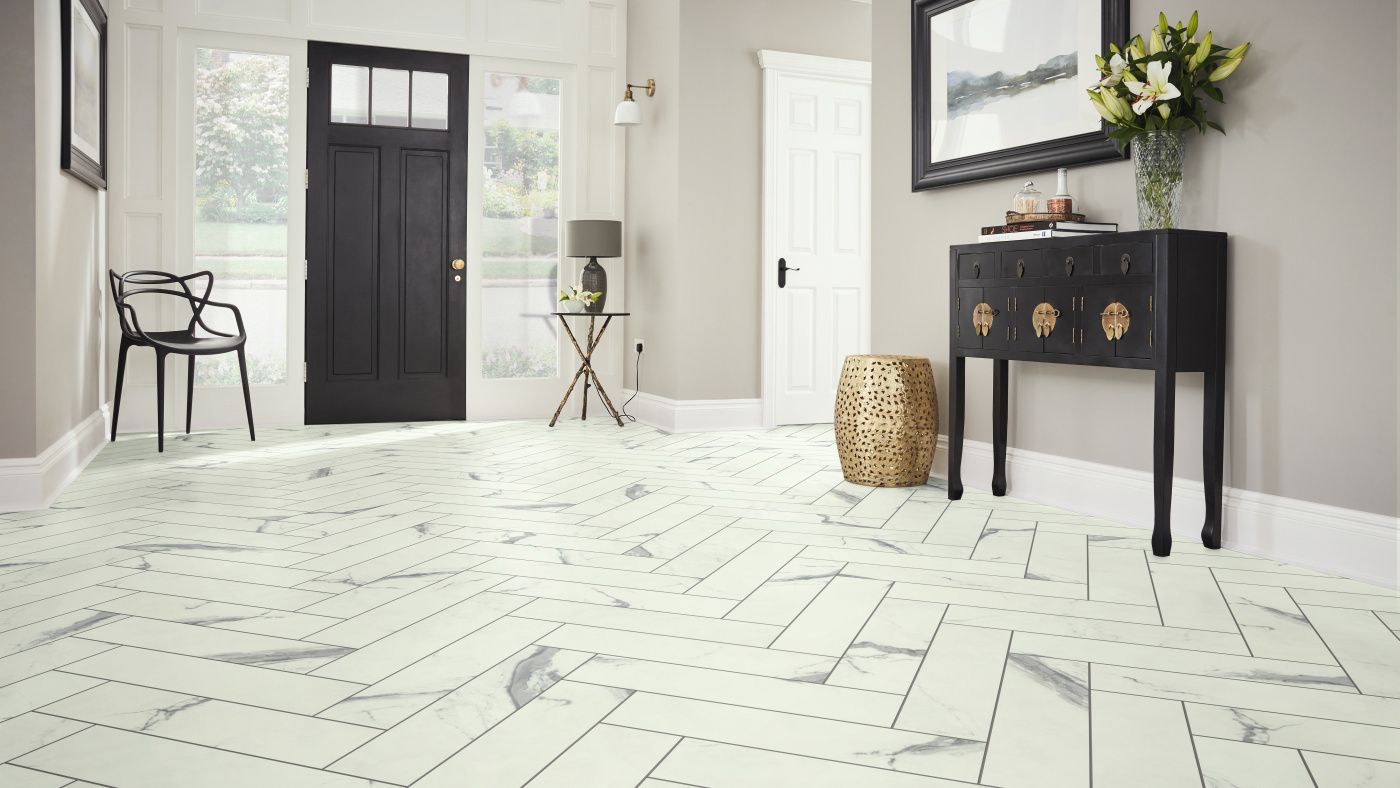 white marble flooring with black design strips in a large modern hallway