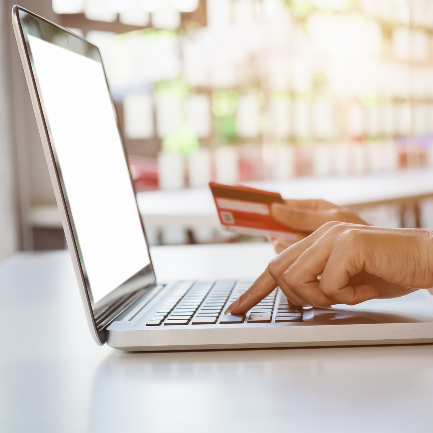 A woman buying items online on a laptop