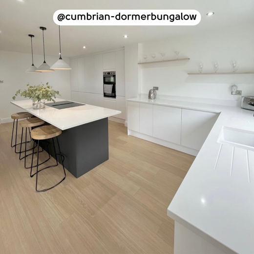 Natural Prime Oak VGW115T floors in an airy kitchen featuring a dark island; photo credit: @cumbrian-dormerbungalow